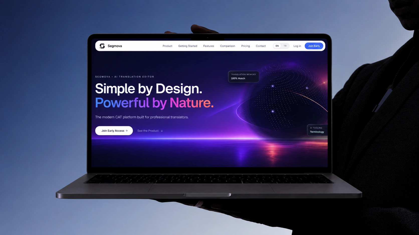 The Segmova homepage open on a laptop, held up by a person in silhouette.